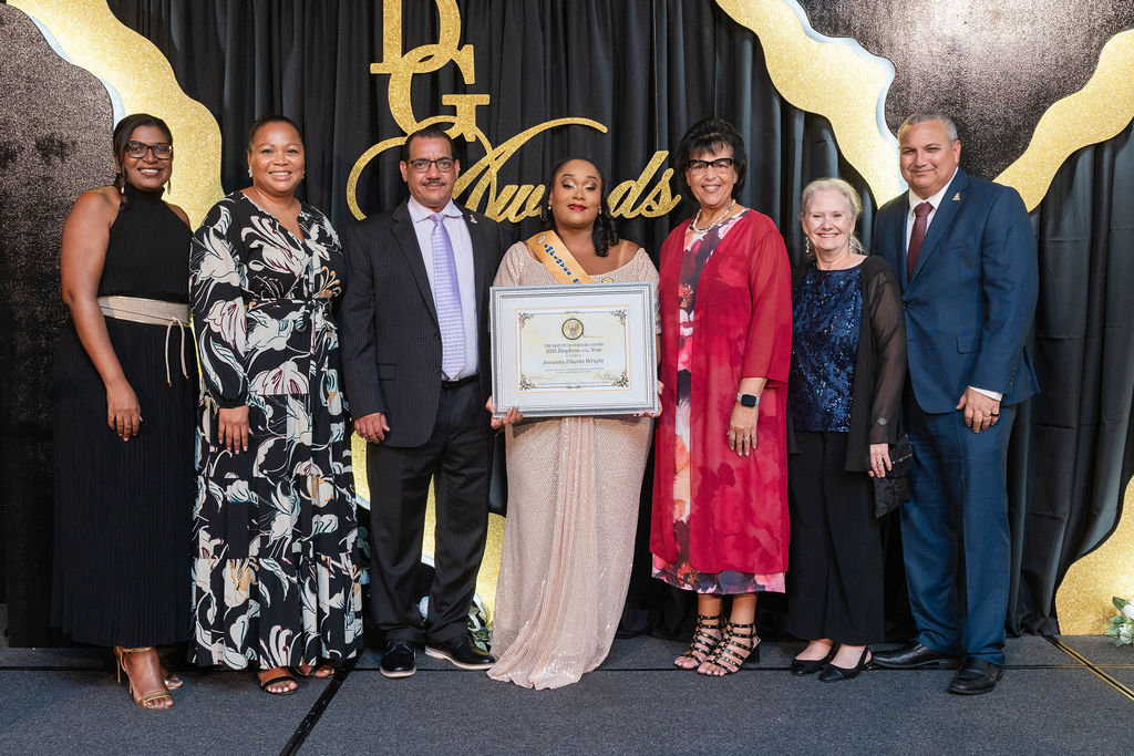 2025 CIG Employee of the Year Jovanna Ebanks Wright (centre), flanked by (L-R) Chief Officers Gloria McField-Nixon and Cetonya Cacho, Minister of Education & Training Honourable Rolston Anglin, Parliamentary Secretary Julie Hunter, Her Excellency The Governor Jane Owen and Deputy Governor Honourable Franz Manderson.